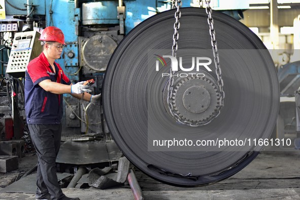 Workers work at a stainless steel material processing enterprise in Qingzhou, China, on October 13, 2024. 