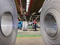 Workers work at a stainless steel material processing enterprise in Qingzhou, China, on October 13, 2024. (