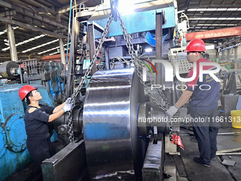 Workers work at a stainless steel material processing enterprise in Qingzhou, China, on October 13, 2024. (