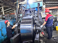 Workers work at a stainless steel material processing enterprise in Qingzhou, China, on October 13, 2024. (