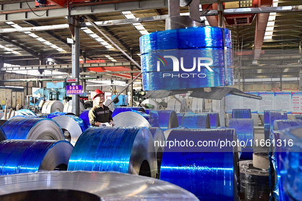 Workers work at a stainless steel material processing enterprise in Qingzhou, China, on October 13, 2024. 