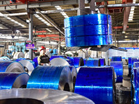 Workers work at a stainless steel material processing enterprise in Qingzhou, China, on October 13, 2024. (