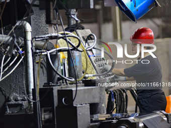 Workers work at a stainless steel material processing enterprise in Qingzhou, China, on October 13, 2024. (