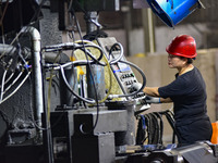 Workers work at a stainless steel material processing enterprise in Qingzhou, China, on October 13, 2024. (