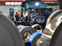 Workers work at a stainless steel material processing enterprise in Qingzhou, China, on October 13, 2024. (