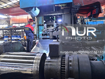 Workers work at a stainless steel material processing enterprise in Qingzhou, China, on October 13, 2024. (