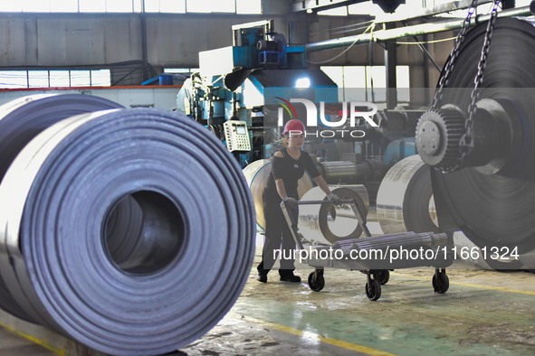 Workers work at a stainless steel material processing enterprise in Qingzhou, China, on October 13, 2024. 