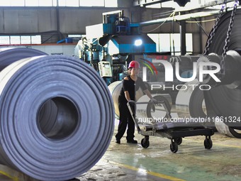 Workers work at a stainless steel material processing enterprise in Qingzhou, China, on October 13, 2024. (