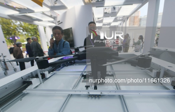 People learn about a smart airport that can carry out automatic take-off and landing of drones at the 2024 Hangzhou (International) Future L...