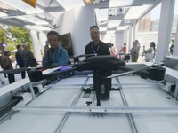 People learn about a smart airport that can carry out automatic take-off and landing of drones at the 2024 Hangzhou (International) Future L...