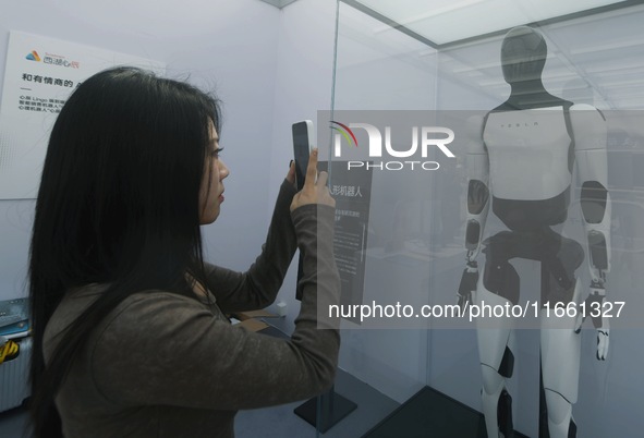 People look at Tesla's humanoid robot ''Optimus'' at the 2024 Hangzhou (International) Future Life Exploration Day in Hangzhou, China, on Oc...