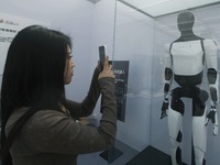 People look at Tesla's humanoid robot ''Optimus'' at the 2024 Hangzhou (International) Future Life Exploration Day in Hangzhou, China, on Oc...