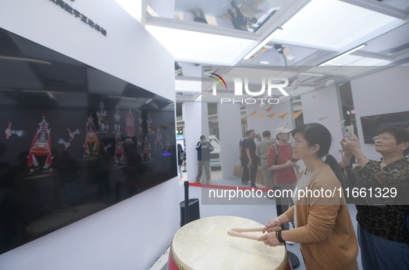 A citizen conducts a digital doll to perform Chaoshan-Ying song and dance at the 2024 Hangzhou (International) Future Life Exploration Day i...