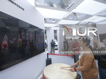 A citizen conducts a digital doll to perform Chaoshan-Ying song and dance at the 2024 Hangzhou (International) Future Life Exploration Day i...