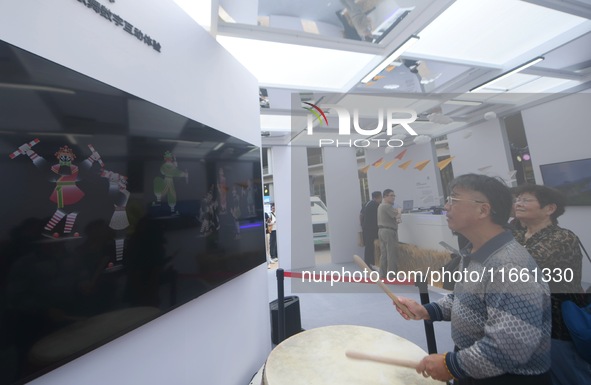 A citizen conducts a digital doll to perform Chaoshan-Ying song and dance at the 2024 Hangzhou (International) Future Life Exploration Day i...