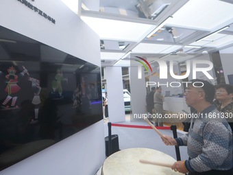 A citizen conducts a digital doll to perform Chaoshan-Ying song and dance at the 2024 Hangzhou (International) Future Life Exploration Day i...