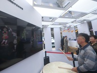 A citizen conducts a digital doll to perform Chaoshan-Ying song and dance at the 2024 Hangzhou (International) Future Life Exploration Day i...