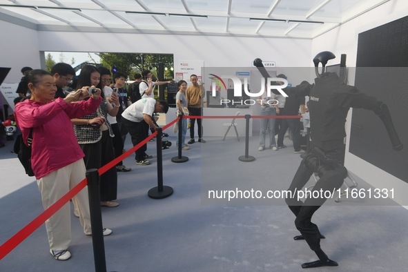 Citizens watch a universal pedestrian robot of Unitree Technology perform a dance performance at the 2024 Hangzhou (International) Future Li...