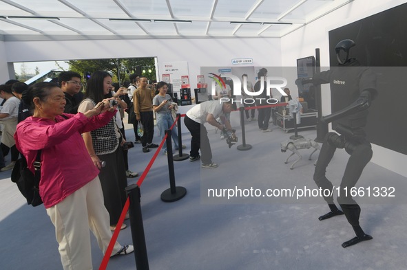 Citizens watch a universal pedestrian robot of Unitree Technology perform a dance performance at the 2024 Hangzhou (International) Future Li...