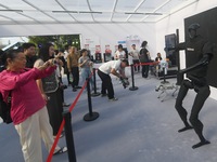 Citizens watch a universal pedestrian robot of Unitree Technology perform a dance performance at the 2024 Hangzhou (International) Future Li...