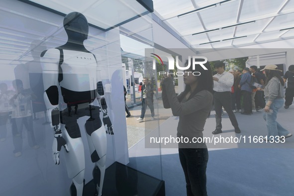 People look at Tesla's humanoid robot ''Optimus'' at the 2024 Hangzhou (International) Future Life Exploration Day in Hangzhou, China, on Oc...