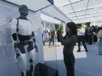 People look at Tesla's humanoid robot ''Optimus'' at the 2024 Hangzhou (International) Future Life Exploration Day in Hangzhou, China, on Oc...