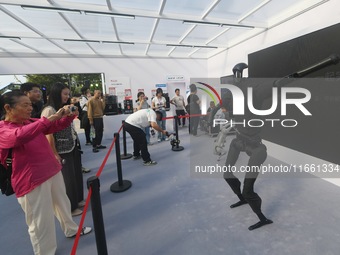 Citizens watch a universal pedestrian robot of Unitree Technology perform a dance performance at the 2024 Hangzhou (International) Future Li...