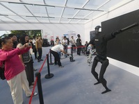 Citizens watch a universal pedestrian robot of Unitree Technology perform a dance performance at the 2024 Hangzhou (International) Future Li...