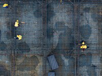 Workers brave the rain as they work at the construction site of the Erhe Junction project of the second phase of the Huaihe River Waterway i...