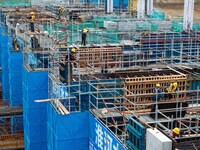 Workers brave the rain as they work at the construction site of the Erhe Junction project of the second phase of the Huaihe River Waterway i...