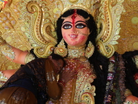 A Hindu woman performs worship of the idol of the Hindu goddess Durga before it is immersed in the Hooghly River during the Durga Puja festi...