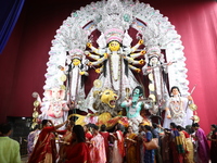 Hindu women perform worship of the idol of the Hindu goddess Durga before it is immersed in the Hooghly River during the Durga Puja festival...