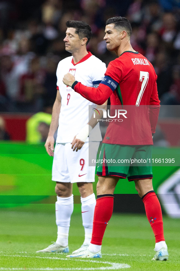 Cristiano Ronaldo reacts after scoring a goal while Robert Lewandowski stands during the UEFA 2024 UEFA Nations League Group A1 match betwee...