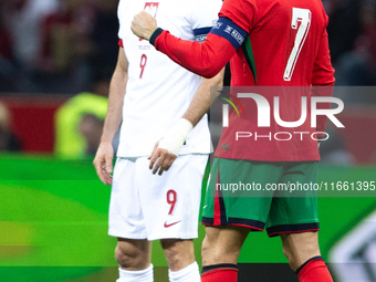 Cristiano Ronaldo reacts after scoring a goal while Robert Lewandowski stands during the UEFA 2024 UEFA Nations League Group A1 match betwee...