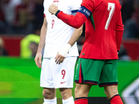 Cristiano Ronaldo reacts after scoring a goal while Robert Lewandowski stands during the UEFA 2024 UEFA Nations League Group A1 match betwee...