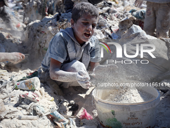 A photo shows Palestinian youths collecting remains of spoiled flour discarded in a makeshift landfill near the tents of displaced people in...