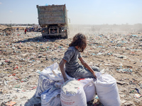 A photo shows Palestinian youths collecting remains of spoiled flour discarded in a makeshift landfill near the tents of displaced people in...