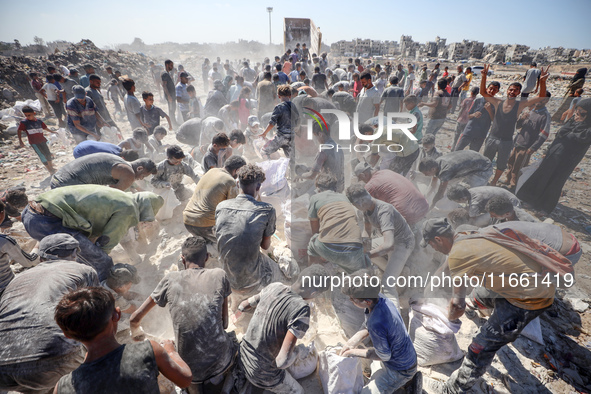 A photo shows Palestinian youths collecting remains of spoiled flour discarded in a makeshift landfill near the tents of displaced people in...