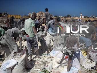 A photo shows Palestinian youths collecting remains of spoiled flour discarded in a makeshift landfill near the tents of displaced people in...