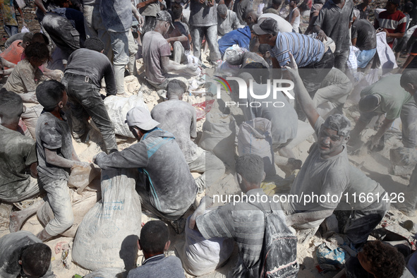 A photo shows Palestinian youths collecting remains of spoiled flour discarded in a makeshift landfill near the tents of displaced people in...