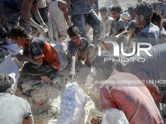 A photo shows Palestinian youths collecting remains of spoiled flour discarded in a makeshift landfill near the tents of displaced people in...