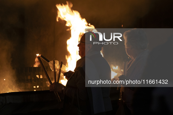 Pilgrims hold candles and pray during the candle procession at the Sanctuary of Fatima, in Fatima, Portugal, on October 12, 2024, on the ann...