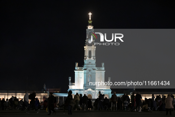 Pilgrims hold candles and pray during the candle procession at the Sanctuary of Fatima, in Fatima, Portugal, on October 12, 2024, on the ann...