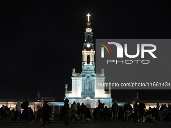 Pilgrims hold candles and pray during the candle procession at the Sanctuary of Fatima, in Fatima, Portugal, on October 12, 2024, on the ann...