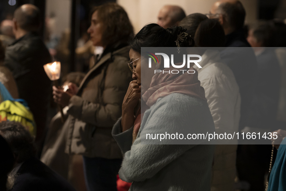 Pilgrims hold candles and pray during the candle procession at the Sanctuary of Fatima, in Fatima, Portugal, on October 12, 2024, on the ann...