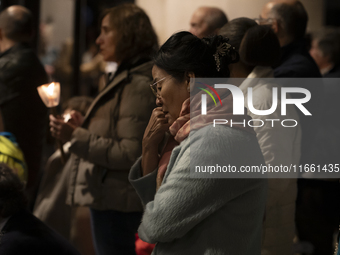 Pilgrims hold candles and pray during the candle procession at the Sanctuary of Fatima, in Fatima, Portugal, on October 12, 2024, on the ann...