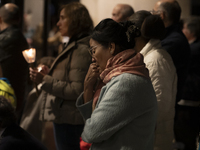 Pilgrims hold candles and pray during the candle procession at the Sanctuary of Fatima, in Fatima, Portugal, on October 12, 2024, on the ann...