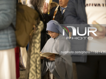 Pilgrims hold candles and pray during the candle procession at the Sanctuary of Fatima, in Fatima, Portugal, on October 12, 2024, on the ann...