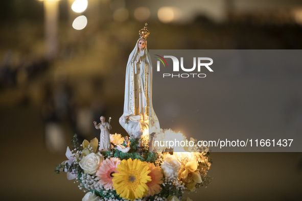 Pilgrims hold candles and pray during the candle procession at the Sanctuary of Fatima, in Fatima, Portugal, on October 12, 2024, on the ann...