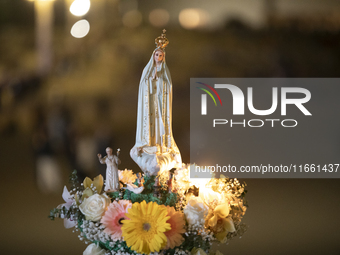 Pilgrims hold candles and pray during the candle procession at the Sanctuary of Fatima, in Fatima, Portugal, on October 12, 2024, on the ann...